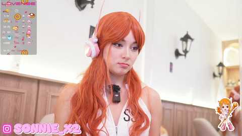 Media: A video of a woman with long, wavy orange hair in a cosplay outfit, featuring a pink bunny ear headband and a white crop top. Background shows a modern room with wooden panels and a lamp.