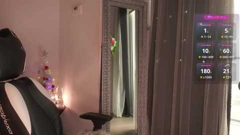 Media: Video of a cozy bedroom with a black gaming chair, a lit Christmas tree, and a mirror reflecting a doorway with a floral arrangement. A virtual reality overlay displays game statistics.