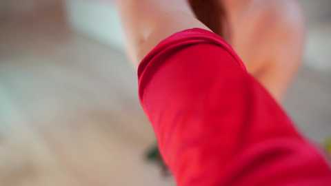 Media: A close-up video of a person's legs in bright red shorts, capturing a dynamic, slightly blurred background. The focus is on the shorts, emphasizing their vibrant color and texture.