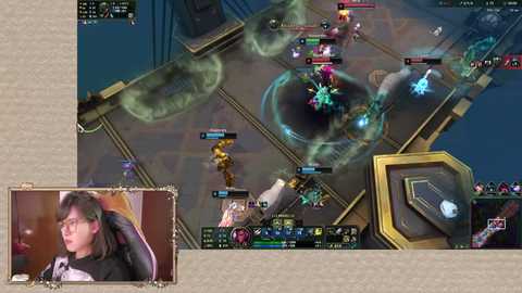 Media: A video shows a League of Legends match with a player in a black jacket and headphones. The game screen features a futuristic, hexagonal arena with glowing blue and red particles.