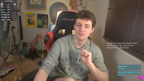 Media: Video of a young man in a grey \"Cincinnati\" shirt, sitting in a red gaming chair, surrounded by gaming equipment, with a text overlay about his gaming experience.