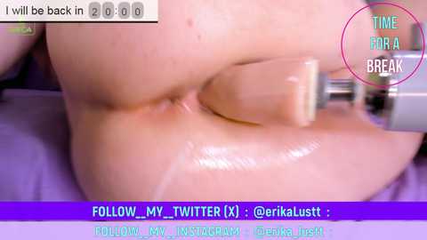 Media: A close-up video of a woman's smooth, pale buttocks being penetrated with a large, beige dildo. The image includes a purple and white text overlay with a Twitter handle.