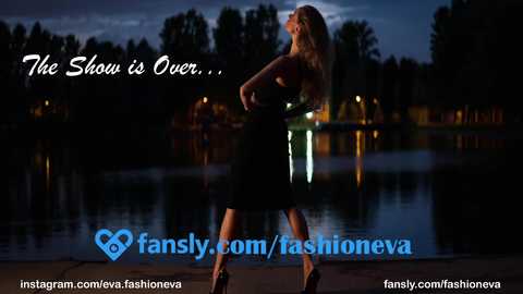 Media: Video of a glamorous blonde woman in a black dress standing by a serene lake at twilight, with the text \"The Show is Over...\" and \"fansly.com/fashioneva\" overlaid.