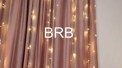 Media: Video of a pink satin curtain adorned with warm white fairy lights, centered with bold white text \"BBR.\" The background is plain white.