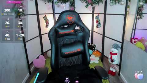 Media: Video of a gamer in a cozy, festive gaming room, seated in a black gaming chair with RGB lighting. The room features a white folding screen, Christmas decorations, and plush toys.