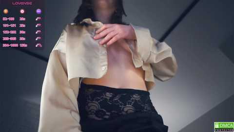 Media: Video of a person in a beige blouse, partially unbuttoned, revealing lace panties, with a live stream overlay displaying temperature and wind speed.