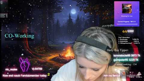 Media: A video of a woman with blonde hair and a black headband, wearing a white shirt, playing a VR game \"CO-WORKING\" in a snowy forest setting.