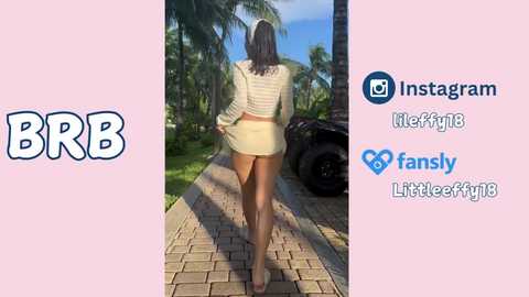 Media: Video of a woman in a short, striped crop top and matching skirt, walking away from a camera on a sunlit brick path, surrounded by palm trees and blue sky. Social media logos and text in the background.