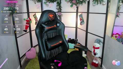 Media: Video of a cozy gaming room with a black leather gaming chair, festive decorations, and plush toys.