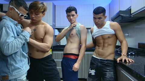 Media: Video of four shirtless Asian men in a modern kitchen. Two lift shirts, one in a white tank, one in blue shorts, another wears a blue shirt.