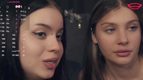 Media: Video of two young women with fair skin and long, straight black hair. One woman has a mole on her cheek. Background shows a digital interface with facial recognition data.