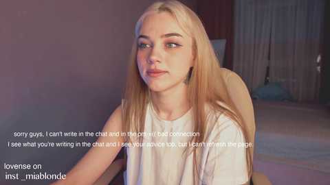 Media: A video of a young, fair-skinned, blonde woman with blue eyes and minimal makeup, wearing a white shirt, sitting indoors. Text overlays: \"I don't want to write in the chat and in the shit and I don't want to hear you either. I don't want to lose you.\