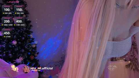 Media: Video of a blonde woman in a white top, partially visible, with a decorated Christmas tree in the background. Live stream overlay shows viewers and stream metrics.