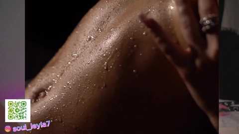 Media: A close-up video of a dark-skinned person's wet, glistening back, with water droplets. The background is blurred, highlighting the person's smooth skin texture. The image has a watermark reading \"SOUL HOY7\" in the bottom left corner.