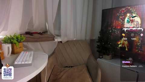 Media: Video of a cozy room with beige armchair, white table, potted plants, white curtains, and a television showing an animated character.