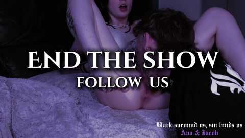 Media: Video: A woman with dark hair, wearing a black bra, lying on a bed. A man, partially visible, is performing oral sex. Text: \"END THE SHOW FOLLOW US.\" Background: Dark, dimly lit room.