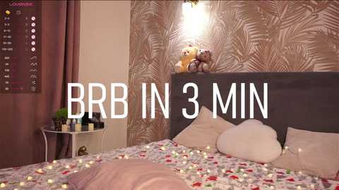 Media: Video of a cozy bedroom with a bed adorned with a Christmas-themed duvet, two stuffed animals, and fairy lights. Text overlays read \"BBR IN 3 MIN.\