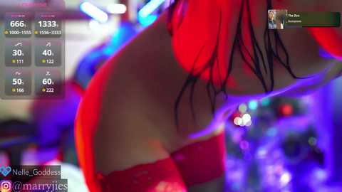 Media: Video of a woman in red lingerie, back to the camera, in a nightclub, with blurred purple and blue lights.