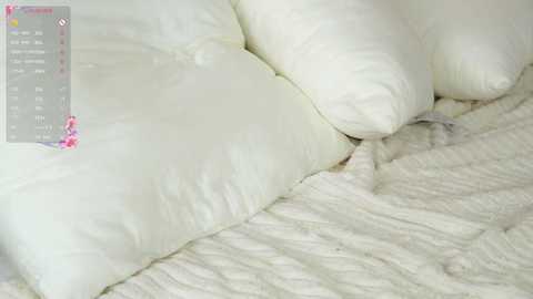 Video of a white, fluffy comforter and matching pillows on a bed, with a digital menu overlay displaying \"Comfort\" on the left.