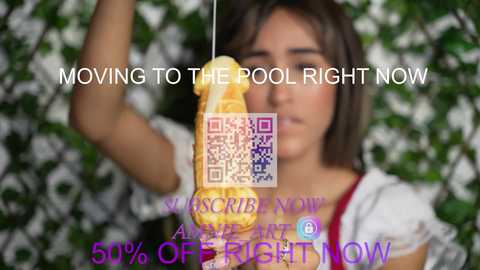 Media: Video of a young woman with shoulder-length brown hair, holding a yellow dildo against a green leafy background. Text overlay: \"MOVING TO THE POOL RIGHT NOW\" and \"50% OFF RIGHT NOW.\