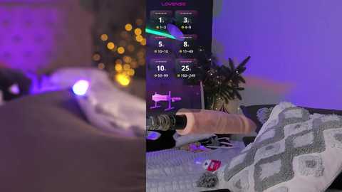 Media: Video of a man using a Fleshlight sex toy while a virtual reality headset displays a game. Background includes a cozy bed with a gray blanket and a potted plant.