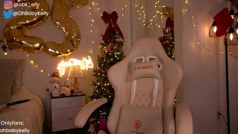 Media: Video of a plush, beige Minecraft Creeper chair in a cozy, dimly lit room adorned with Christmas decorations, including a lit tree and festive garlands.