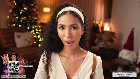 Media: Video of a young Black woman with curly hair, wearing a beige dress, smiling, in a warmly lit, festive living room with Christmas decor, and text overlays promoting a promotion.