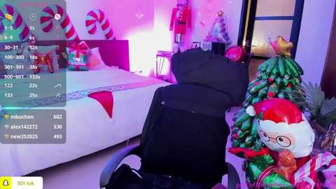 Media: A video of a cozy bedroom with a white bed, Christmas decorations, and a plush Elf on the Shelf toy. The room is lit with purple and pink lights, adding a festive ambiance.