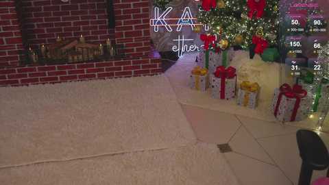 Media: A video of a festive indoor scene with a plush white carpet, red brick fireplace, Christmas tree adorned with red and gold ornaments, and gift boxes wrapped in red and white paper.