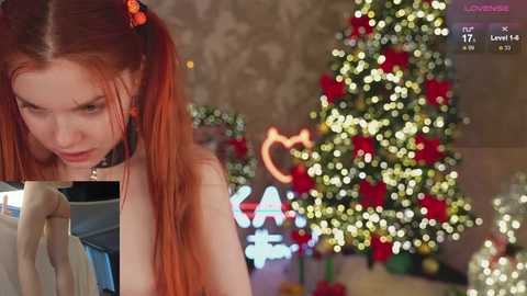 Media: Video of a young woman with red pigtails and a black choker, intensely reading a book, in a warmly lit room with a Christmas tree adorned with red and white ornaments.