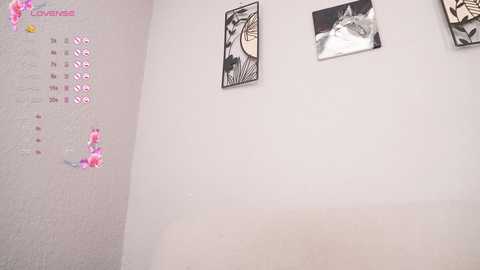 Media: A video of a beige wall adorned with a pink calendar and two black-and-white comic-style posters depicting a person's head and a wolf.