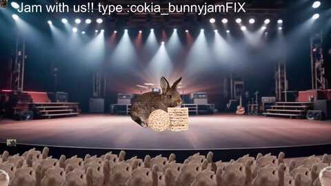 Media: A video of a CGI rabbit floating above a stadium crowd during a concert, with bright stage lights and a text overlay: \"Jam with us! type: ookia bunnyjamFX.\