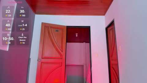 Media: Video of a narrow, dimly lit hallway with red-tinted lighting. Wooden door slightly ajar reveals a white refrigerator. Left wall features a digital display with time and temperature readouts.