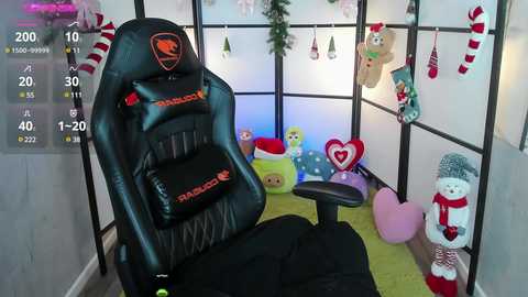 Media: A video of a cozy, festive gaming room with a black gaming chair, plush toys, and holiday decorations, including a Santa hat and heart-shaped pillows, against a white room divider.