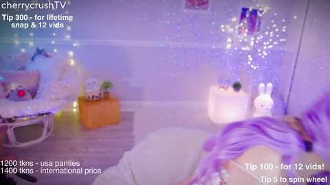 Media: Video of a pastel-colored room with a chandelier, bunny decor, and a white furry blanket on the floor.