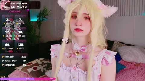 Media: Video of a young woman with pale skin, long blonde hair, wearing a pink cat ear headband, frilly white dress, and large red lipstick. Background shows a messy room with a bed and colorful pillows.