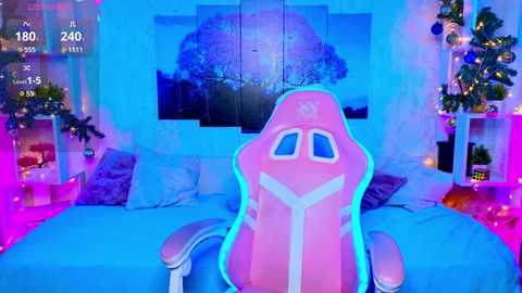 Media: A vibrant video of a pink gaming chair with a glowing outline, in a room adorned with blue and purple lighting, decorated with Christmas trees and framed nature scenes.