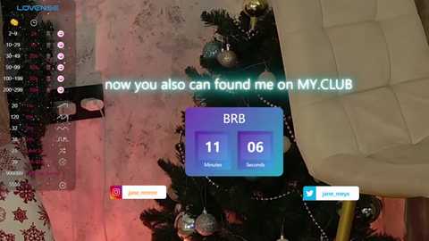 Media: Video of a festive living room with a decorated Christmas tree, a plush beige chair, and a digital screen displaying \"now you can find me on MY CLUB\" with an RB button.