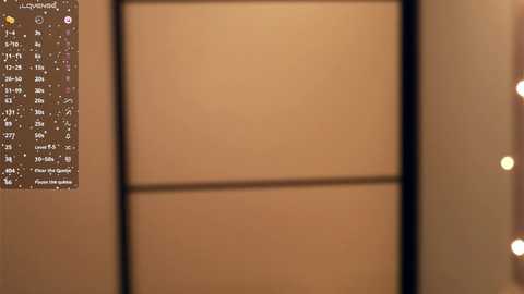 Video of a beige wall with a white grid pattern, featuring a calendar with numbered days and events, and a blurry, out-of-focus background.