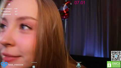 A close-up video of a young woman with light brown hair, wearing a red bow, captured in a virtual reality setting with digital overlays and text.