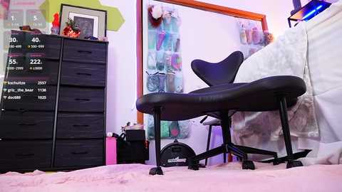 Media: Video of a modern bedroom with a black ergonomic chair, black dresser, white bed, colorful artwork, and movie-themed decor.