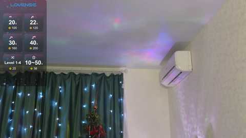 Media: Video of a living room with a large TV, air conditioner, and blue curtains with fairy lights. Weather forecast and temperature display on the screen.