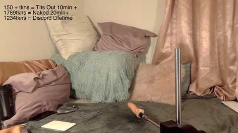 Media: A video shows a messy room with a pink curtain, a gray blanket, and a tool on a brown carpet. Text in the corner reads, \"170 cm x 100 cm + This Outfit = 1728 cm = 12.24kns - Disorded Lifetime.\