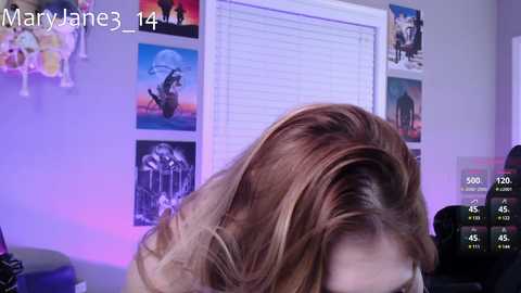 Media: A video showing a close-up of a woman with shoulder-length, wavy brown hair, in a room with purple lighting, Star Wars posters, and a video game controller.