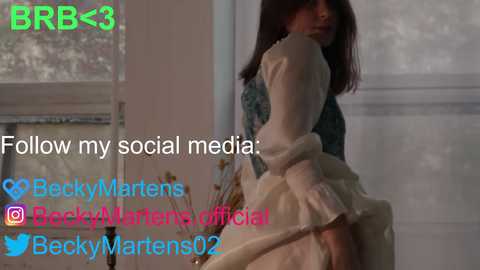 Media: Video of a young woman in a white dress, taken indoors with soft lighting. Text overlays promote her social media and mentions \"BeckyMarlenasOfficial1\" and \"BeckyMartens02.\