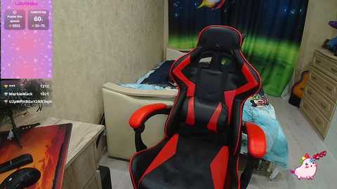 Media: Video of a gaming setup featuring a black and red gaming chair, beige carpet, a TV screen showing game details, and a bed with blue bedding.