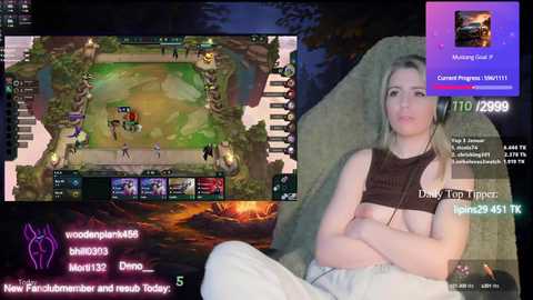 Video of a woman playing League of Legends on a gaming laptop, wearing a black tank top, revealing her breasts.