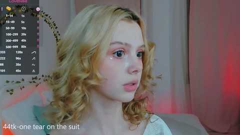 Media: A close-up video of a blonde woman with wavy hair, wearing a light-colored top, crying, with a caption reading \"44k-1 fear on the suit.\