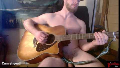 Media: Video of a nude man with a beard, playing an acoustic guitar indoors. Background shows a painting of a forest and wooden door. Text reads, \"Cum at goal!\