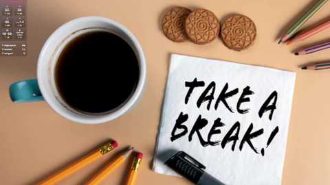 Media: A video of a workspace featuring a coffee cup, tea cookies, colored pencils, a notepad with \"TAKE A BREAK!\" in bold letters, and a black pen.